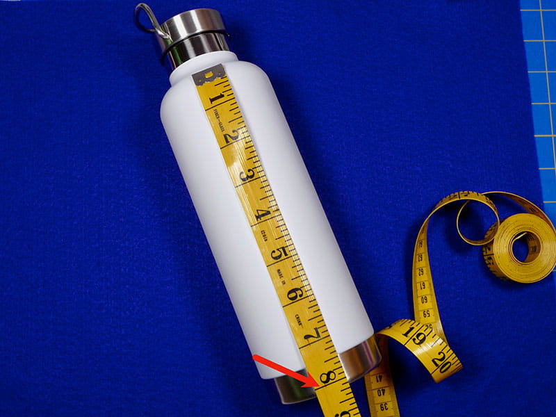 A white water bottle with a measuring tape